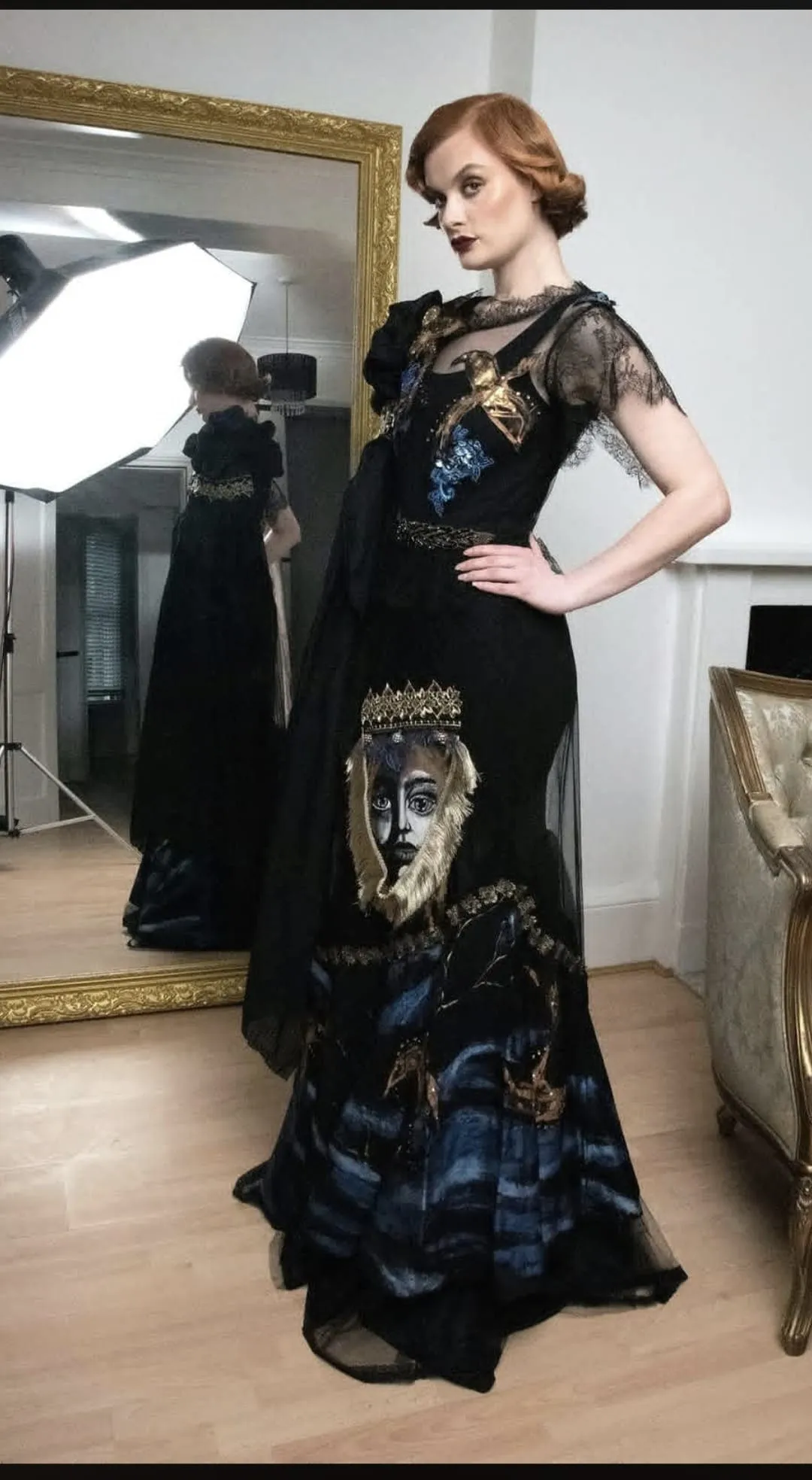 Black gown with a hand-painted face and embroidery